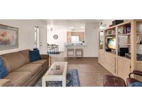 Inviting living room with open floorplan, hardwood floors and breakfast bar seating at 5235 Caspian Springs St # 101, Las Vegas, NV 89120