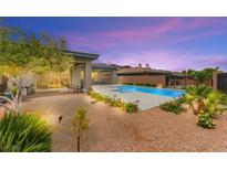 Beautiful backyard pool with desert landscaping, and covered patio, ideal for outdoor living at 59 Reflection Bay Dr, Henderson, NV 89011
