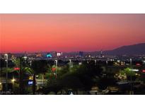Stunning skyline view of the Las Vegas strip during sunset with palm trees in the foreground at 731 Glowing Horizon St, Henderson, NV 89052