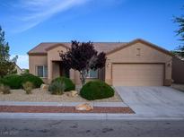 Charming single-story home with a two-car garage and desert landscaping at 7668 Broadwing Dr, North Las Vegas, NV 89084