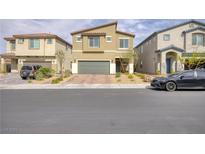 Charming two-story home features a brick driveway, manicured landscaping, and attached two-car garage at 8316 Gold River Ct, Las Vegas, NV 89113