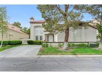 Charming two-story home with stucco exterior, desert landscaping, and a concrete driveway at 8340 Carmel Ridge Ct, Las Vegas, NV 89113