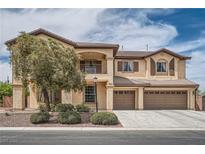 Two-story home with a three-car garage, balcony and manicured landscaping providing curb appeal at 8431 Jeremiah Grove St, Las Vegas, NV 89123