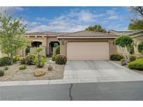 Charming single-story home featuring a two-car garage and desert landscaping with a tiled roof at 10241 Premia Pl, Las Vegas, NV 89135
