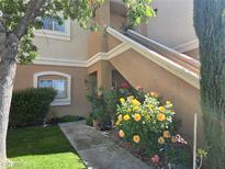 Charming condo featuring a landscaped entrance with vibrant flowers and a well-maintained walkway at 10500 Pine Pointe Ave # 206, Las Vegas, NV 89144