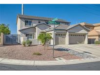 Two-story home showcasing a two-car garage, landscaped front yard, and attractive neutral-toned stucco at 10654 Robin Hill Ave, Las Vegas, NV 89129