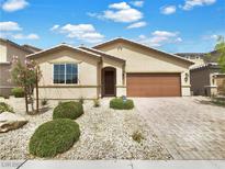 Charming single-story home featuring desert landscaping, a covered entry, and a two-car garage at 138 Scarlett View Ave, North Las Vegas, NV 89031