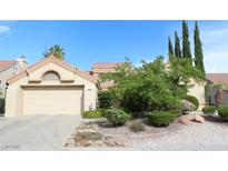 Charming single-Gathering home featuring a two-car garage, desert landscaping, and a well-maintained front yard at 2633 Legend Dr, Las Vegas, NV 89134