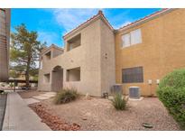 A two-story home features stucco exterior, red tile roof, and low-maintenance landscaping at 3151 Soaring Gulls Dr # 2034, Las Vegas, NV 89128