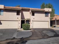 Beige two-story townhome with a two-car garage and a red tile roof, located on a sunny lot at 3621 Laguna Verde Way, Las Vegas, NV 89121
