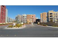 Manhattan Condominiums community entrance with colorful buildings, manicured landscaping, and well maintained driveways at 50 E Serene Ave # 321, Las Vegas, NV 89123