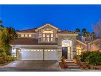 Stunning two-story home with a three-car garage, tile roof, and lush landscaping at 8808 Rozetta Ct, Las Vegas, NV 89134