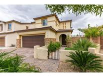 Charming two-story home featuring desert landscaping, a two-car garage, and a gated front entry in a suburban neighborhood at 1417 Brushback Ave, Henderson, NV 89074