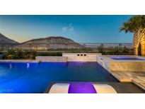 Stunning pool and spa with mountain views and lush landscaping create a serene outdoor oasis at 2910 Raywood Ash Dr, Las Vegas, NV 89138