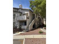 Inviting condo featuring a quaint balcony, a private entrance, and lush landscaping at 3059 Key Largo Dr # 203, Las Vegas, NV 89120
