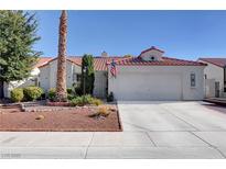 Charming single-story home with a tile roof, low-maintenance landscaping, and an attached two-car garage at 3913 Cutting Horse Ave, North Las Vegas, NV 89032