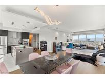 Bright living room featuring open concept kitchen, dining area and lounge area with city views at 4471 Dean Martin Dr # 1210, Las Vegas, NV 89103