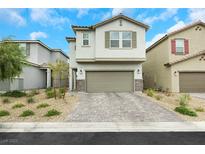 Charming two-story home featuring a paved driveway, attached garage, and low-maintenance landscaping at 5016 Kaslo Ave, Las Vegas, NV 89139