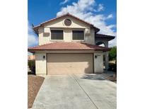 Charming two-story home featuring a tile roof and a two-car garage, perfect for suburban living at 5044 Signal Dr, Las Vegas, NV 89130