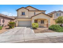 Charming two-story home with a two-car garage, a cozy porch, and well-maintained landscaping at 5060 Blue Rose St, North Las Vegas, NV 89081