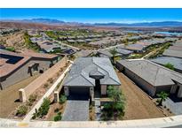 Stunning aerial view of a single-Gathering home showcasing the beautifully landscaped front yard and surrounding community at 54 Mirage View Dr, Henderson, NV 89011