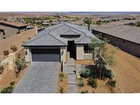 Beautiful single-Gathering home featuring a well-manicured front yard and an attached two-car garage at 54 Mirage View Dr, Henderson, NV 89011