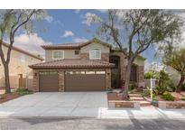 Charming two-story home with a three car garage, tile roof, and beautifully landscaped front yard at 5404 Ireland St, Las Vegas, NV 89149