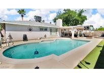 Refreshing pool with a clean concrete surround and plenty of space for lounging under blue, cloudy skies at 5424 Neosho St, Las Vegas, NV 89120