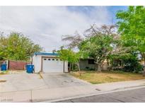 Charming single-story home with a two-car garage and mature trees at 5600 W Bartlett Ave, Las Vegas, NV 89108