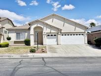 Charming single-story home featuring a three-car garage and well-maintained landscaping at 8084 Black Orchid Ave, Las Vegas, NV 89131