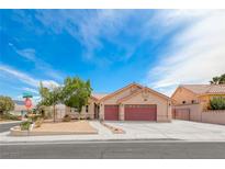 Charming single-story home with a well-manicured front yard and a three-car garage in a quiet neighborhood at 902 Little Raven St, Henderson, NV 89002