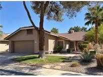 Charming single-story home featuring a two-car garage and nicely landscaped front yard at 2022 Big Bend Way, Henderson, NV 89074
