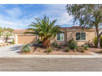 Inviting single-story home with desert landscaping, covered entry and attached two-car garage at 2489 Black River Falls Dr, Henderson, NV 89044