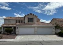 Two-story home featuring a three-car garage and a terracotta-tile roof at 1003 Dover Glen Dr, North Las Vegas, NV 89031