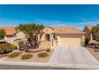 Charming single-story home featuring a two-car garage, desert landscaping, and a well-maintained front yard at 2219 Sawtooth Mountain Dr, Henderson, NV 89044