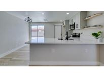 Modern kitchen features white countertops, stainless steel appliances, and an open design that is great for entertaining at 3330 Rio Grande St, Las Vegas, NV 89115