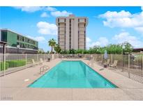 Outdoor pool with lounge chairs and desert landscaping, in front of high rise building at 3930 University Center Dr # 202, Las Vegas, NV 89119