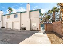 Charming townhome features a two-car garage, light exterior, and well-maintained landscaping at 5025 Starfinder Ave, Las Vegas, NV 89108