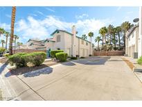 Inviting two-story exterior with well-maintained landscaping, a terracotta-colored roof and a long driveway at 5025 Starfinder Ave, Las Vegas, NV 89108
