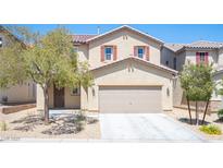 Two-story home with a two-car garage, desert landscaping and inviting front entrance at 5638 Jelsma Ave, Las Vegas, NV 89141