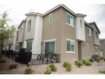 Charming townhome featuring stucco siding, a cozy patio with barbecue, and a low-maintenance gravel yard at 6824 Satin Silver Ct, North Las Vegas, NV 89086