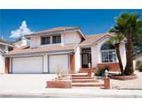 Charming two-story home featuring a two-car garage, tile roof, and well-maintained landscaping at 9704 Falling Star Ave, Las Vegas, NV 89117