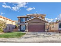 Two-story home featuring a brown facade, two-car garage, and a well-maintained lawn at 1481 Rancho Ridge Dr, Henderson, NV 89012