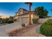 Beautiful two-story home with a two-car garage, desert landscaping, and a well-manicured lawn at 150 Wentworth Dr, Henderson, NV 89074