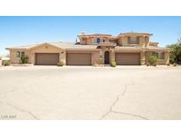 Charming multi-story home featuring a three-car garage and well-maintained desert landscaping at 31 Via Mantova # 1, Henderson, NV 89011