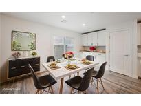 Bright dining area features modern table setting, sliding glass doors, and stylish decor at 376 Yellow Finch Ln, Henderson, NV 89012