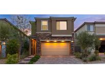 Inviting two-story home with brick accents and a spacious two-car garage at 397 Purple Sandpiper St, Las Vegas, NV 89138