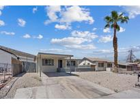 Single story home with desert landscaping and a carport, beneath a partly cloudy sky at 429 N 10Th St, Las Vegas, NV 89101