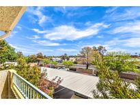 Scenic view from the balcony overlooking the covered parking area and lush landscaping under a partly cloudy sky at 4809 S Torrey Pines Dr # 201, Las Vegas, NV 89103