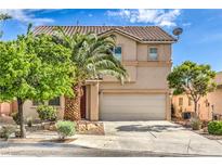 Charming two-story home featuring a well-maintained front yard and attached two-car garage at 5005 Justice Creek Ave, Las Vegas, NV 89131
